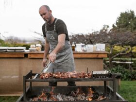 Photos of food and drink at Upland's Dark Shed event. Shows moody lighting and open fire cooking.