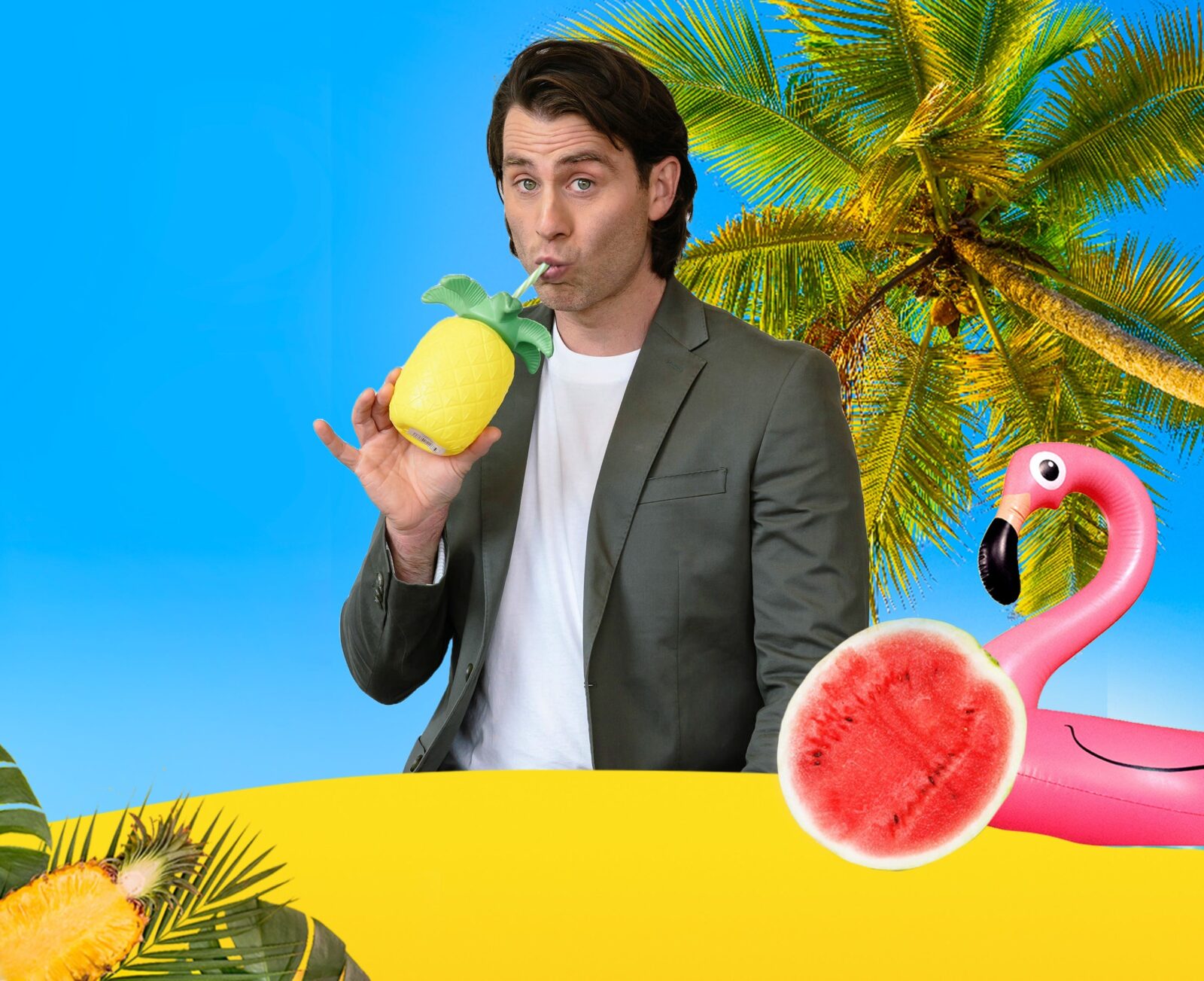 Jimmy, is dressed in a jacket, on a beach, drinking from a pineapple