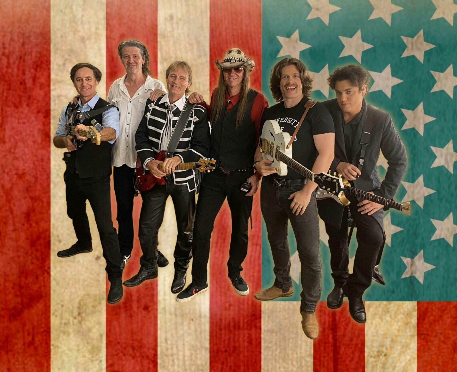 A group of country performers stand in front of the American flag