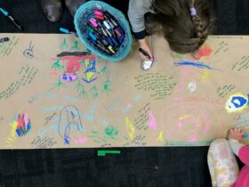 Photograph of an artwork created by children, including writing
