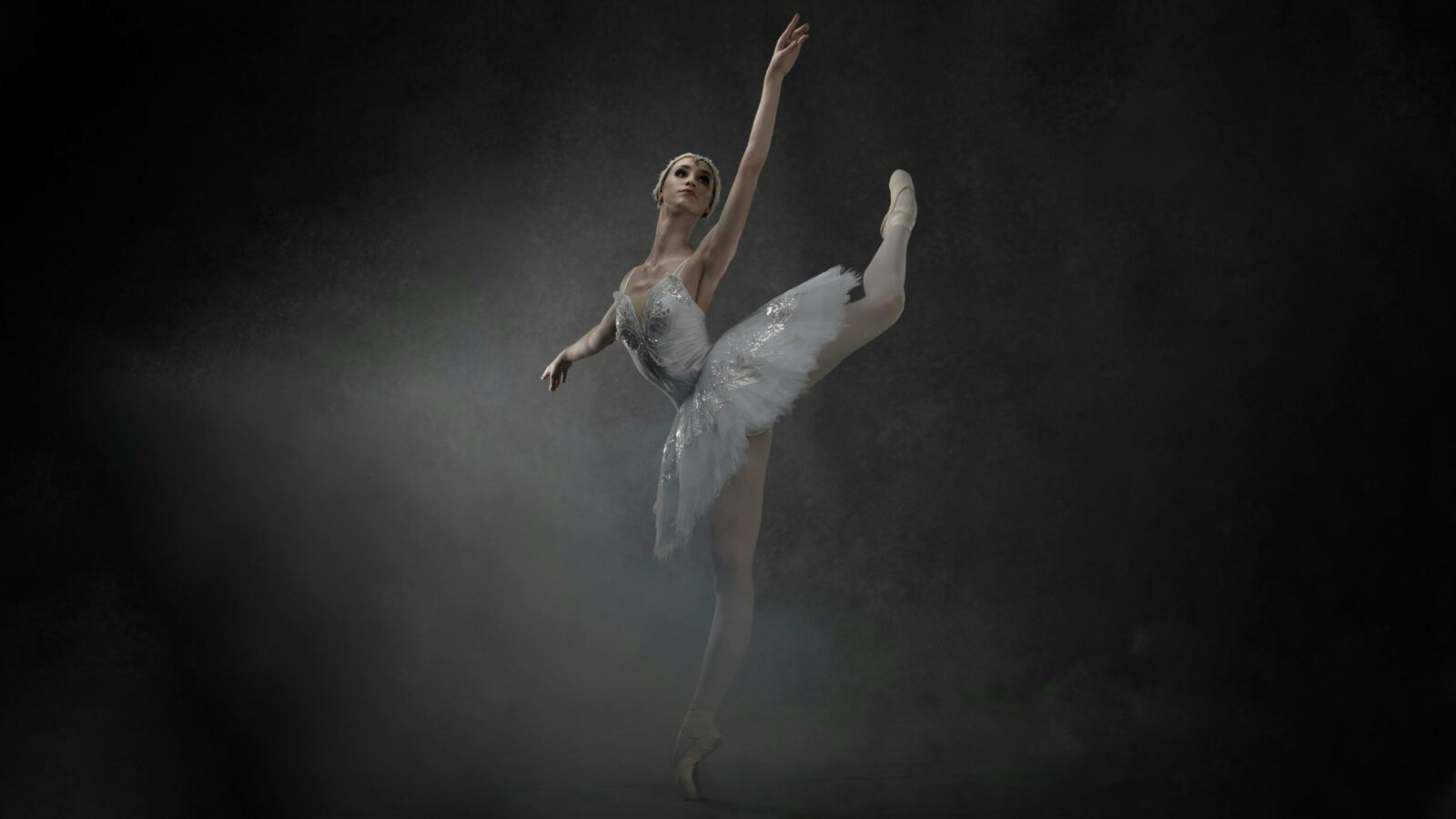 A ballerina dancing on a moody stage