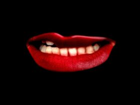 Bright red lips on a black background