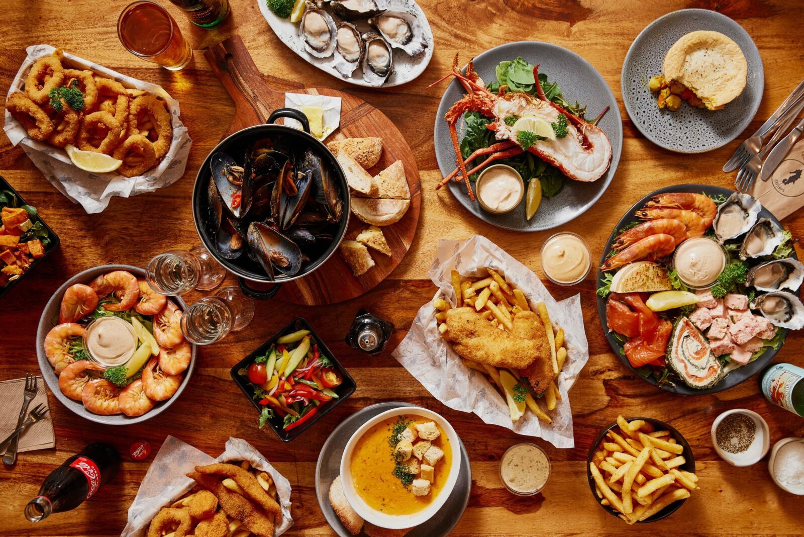 A table displaying a range of seafood dishes including crayfish, oysters, fish & chips and more
