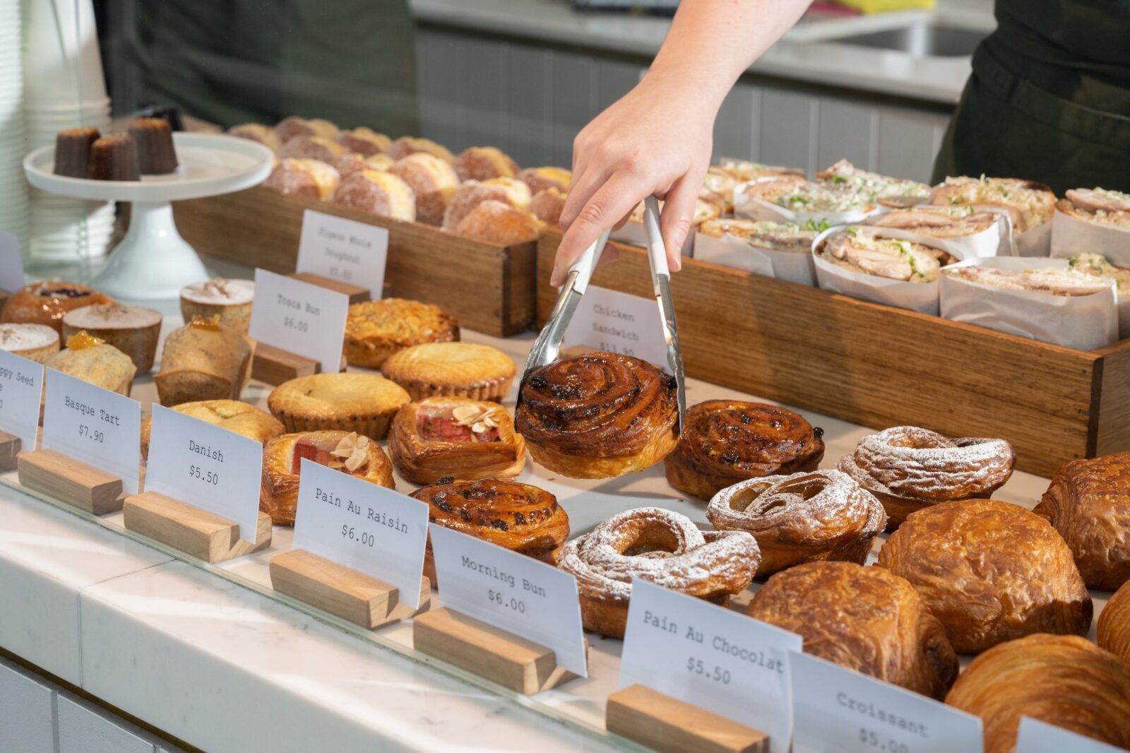 Shop cabinet bursting with cakes, pastries and sandwiches