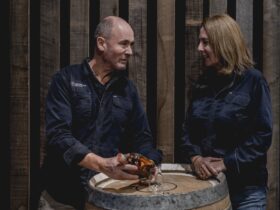 Cam and Suzy Brett with a barrel and whisky