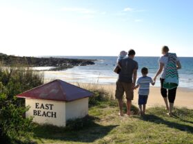 This image shows a family walking towards East Beach.