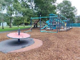 Park with trees and children's playground equipment
