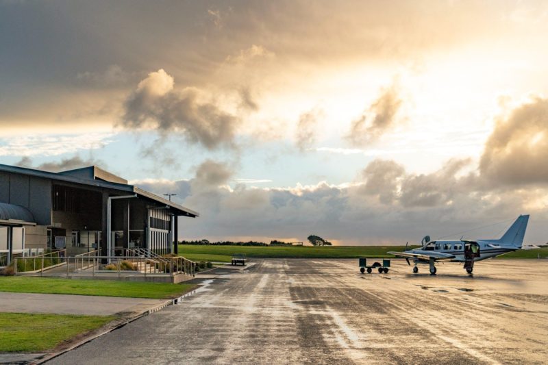 Sun streaming through clouds over the aircraft apron at King Island Airport