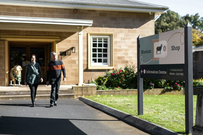 Man and women exiting the front of the Tasmanian Wool Centre in Ross