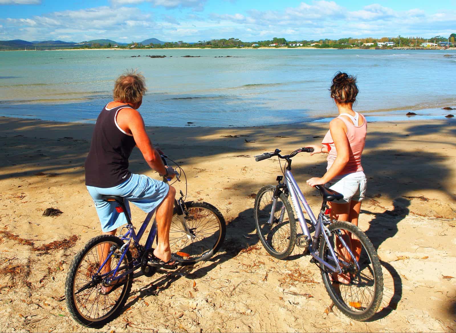 Two people on the beach with their bikes