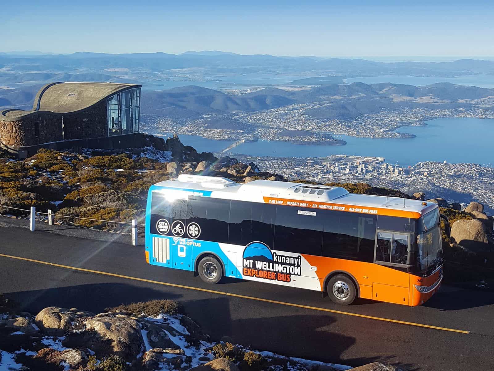 Bus parked at the summit of the mountain with panoramic views of the city below.