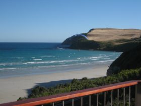 view from balcony across beach towards the cape of Cape Bridgewater