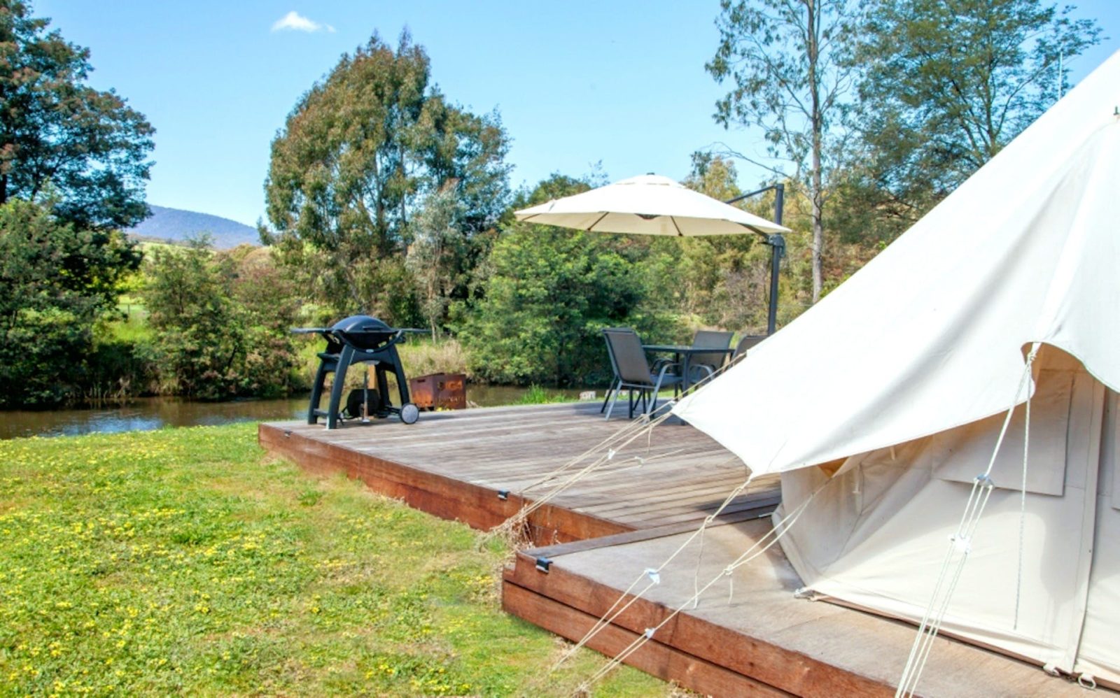 Glamping tent with deck and BBQ overlooking the river
