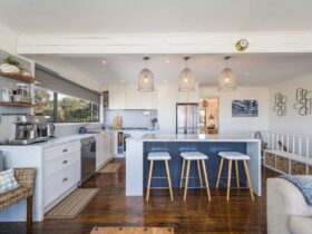 Beautiful space in blues and white, timber floor. Kitchen with island bench and modern amenities