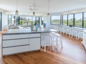 Bright light kitchen meals & living area with windows all sides and great views to surf