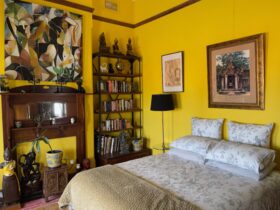 Yellow room with Cambodian pictures and artefacts..