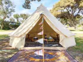Bell tent pitched and furnished by Happy Glamper