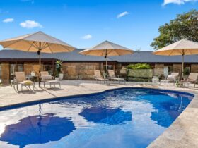 Heated pool, poolside seating with commercial umbrellas.
