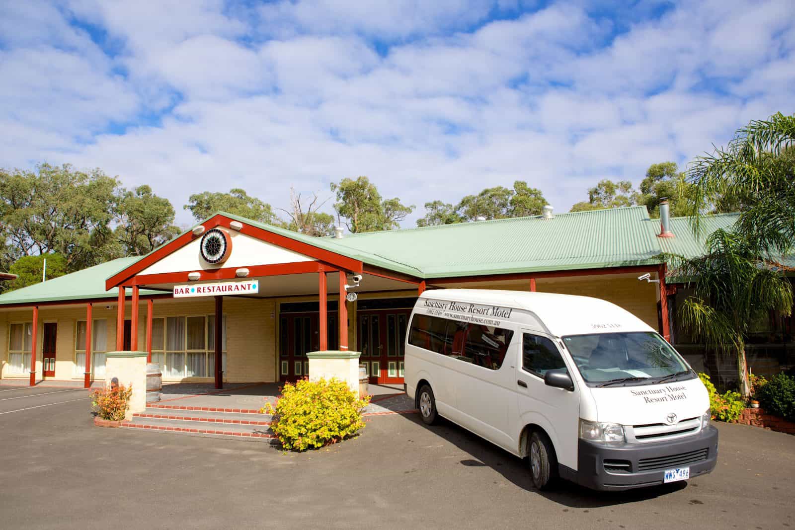 Sanctuary House Restaurant with guest mini bus parked outside