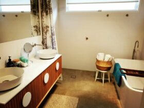 Bathroom wetroom with modern double vanity and bath