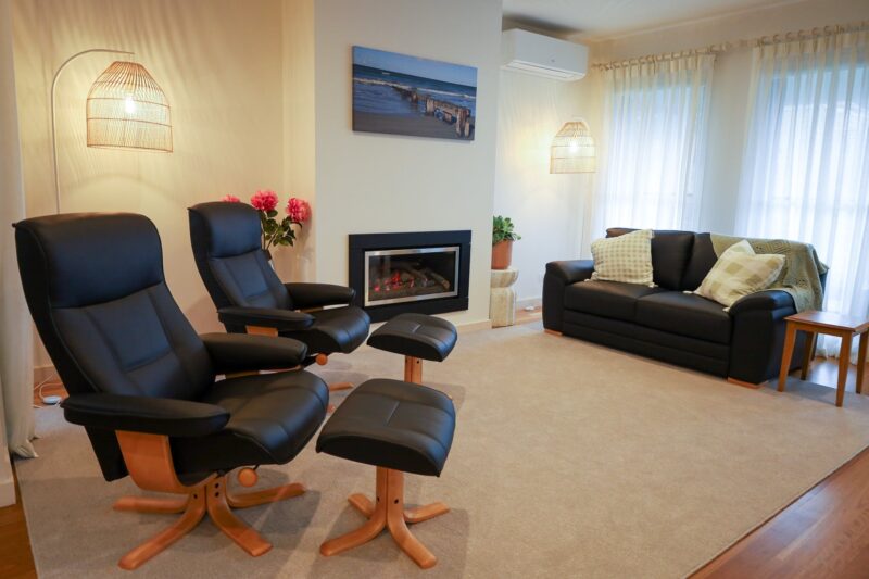 Living room with chairs, sofa and gas log fire