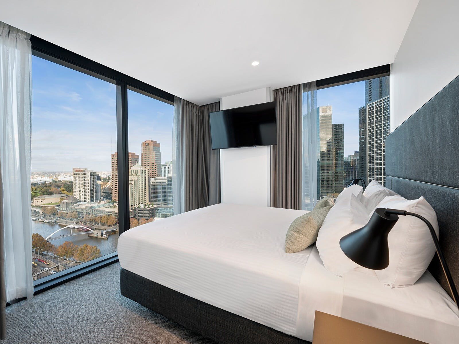 Vibe Hotel Melbourne room with floor to ceiling windows looking out to the city
