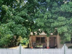 Wallace Cottage- house front view. Picket fence
