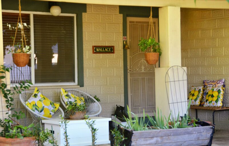 Porch area, seats, front door, window, plants