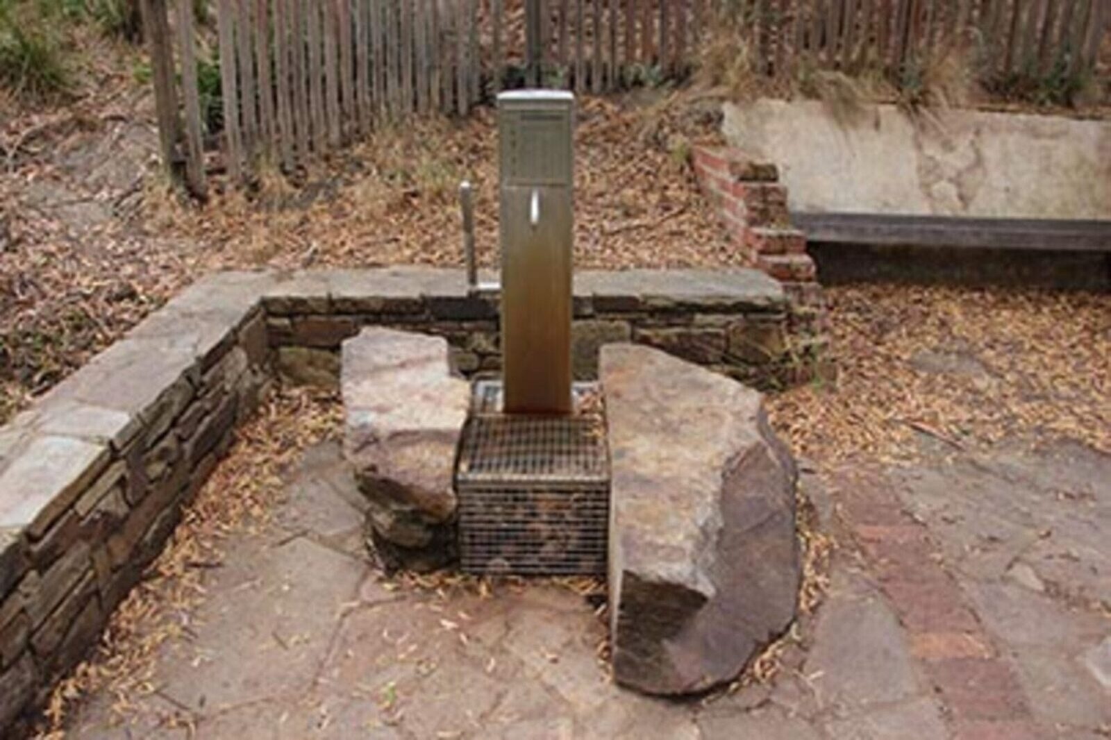 A tap surrounded by rocks