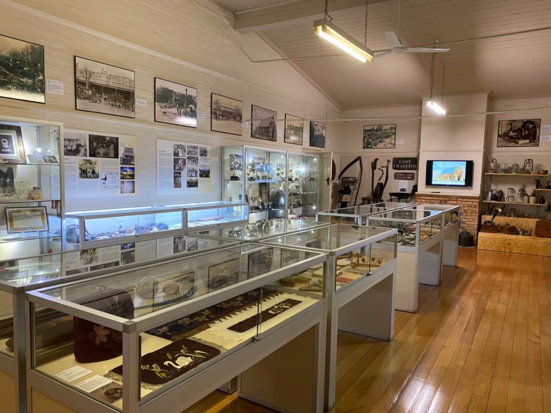 Main display room with large photos on walls and several showcases.