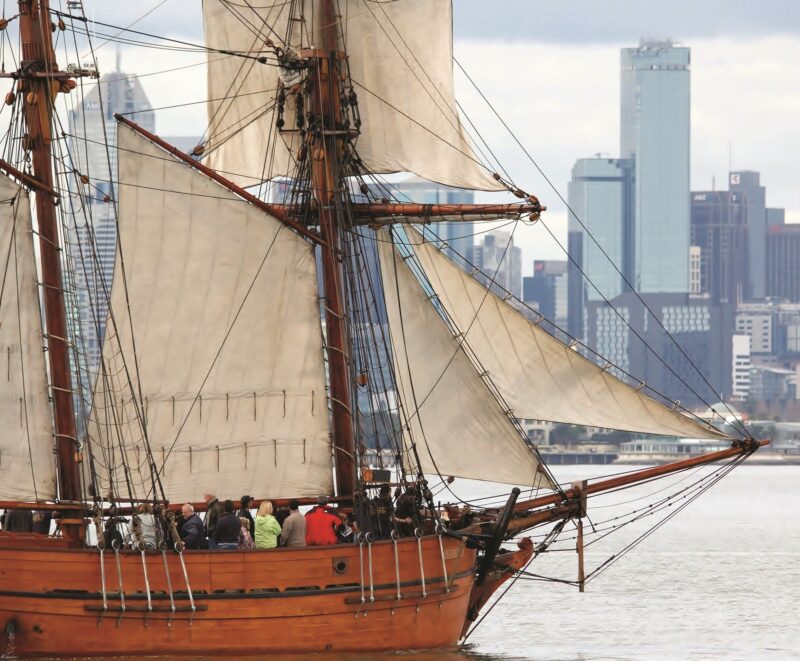 Enterprize in Hobson's Bay - a topsail schooner sailing in front of the city of Melbourne