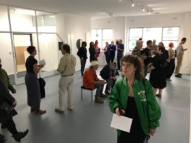 A photo of people enjoying an art opening at Five Walls Gallery