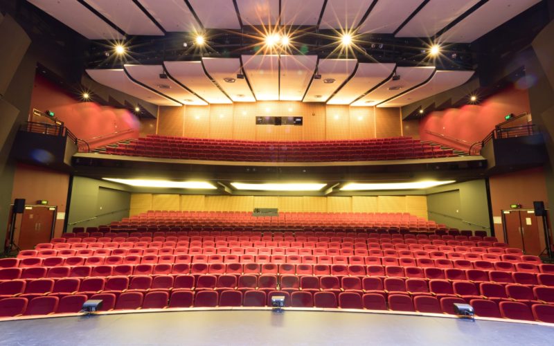 An 800 seat auditorium photo taken from stage looking into stalls and dress circle seating.