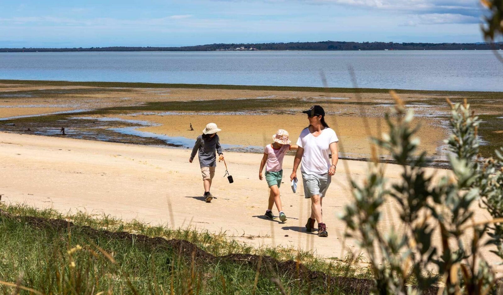 Family walking along French Island Beach