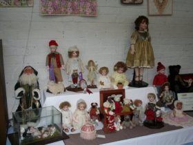 A display of antique reproduction dolls