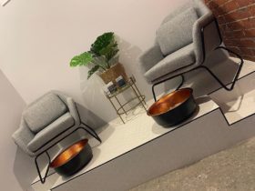 two grey chairs with bowls underneath for pedicures