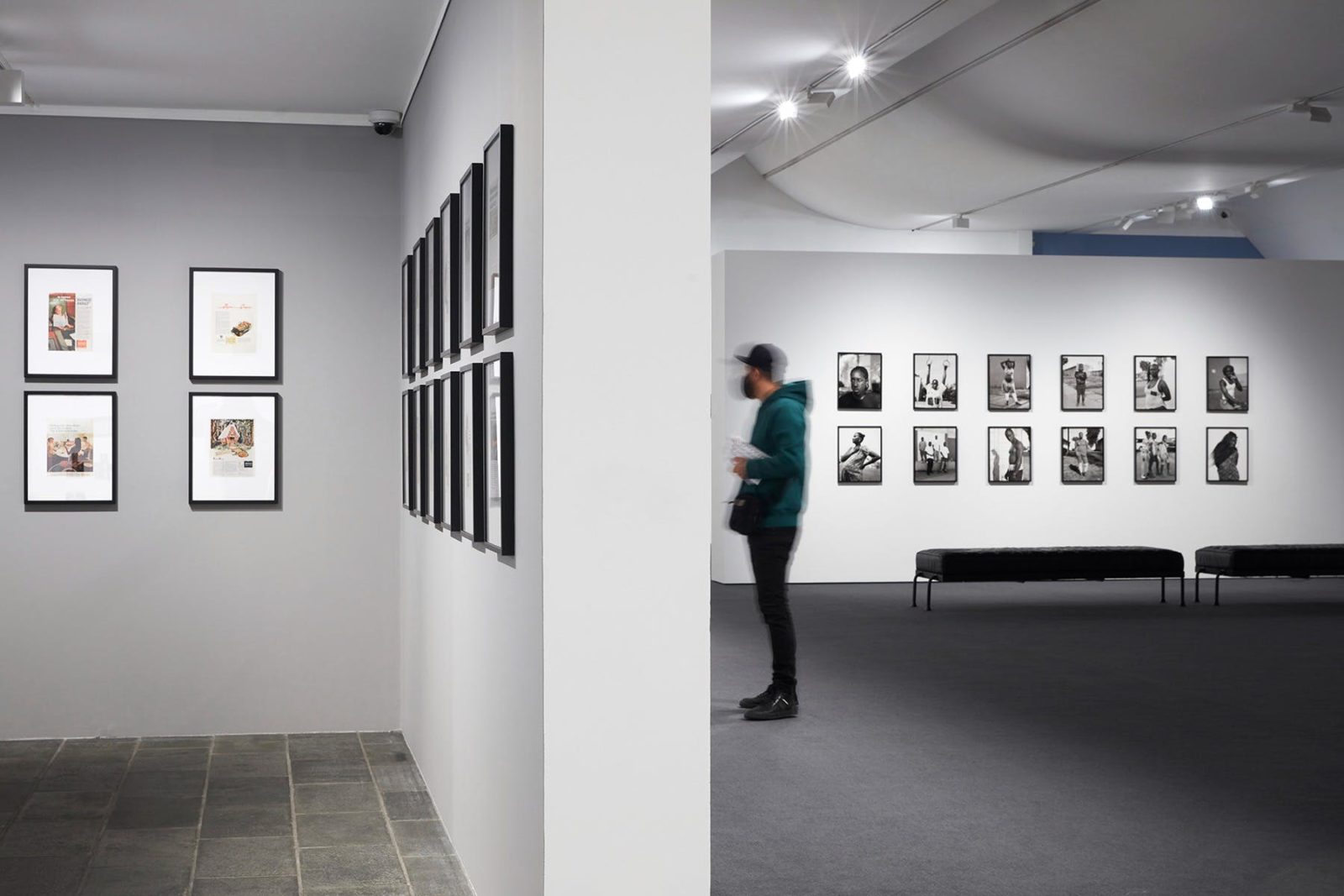A man looks at photographs on display in the Gallery