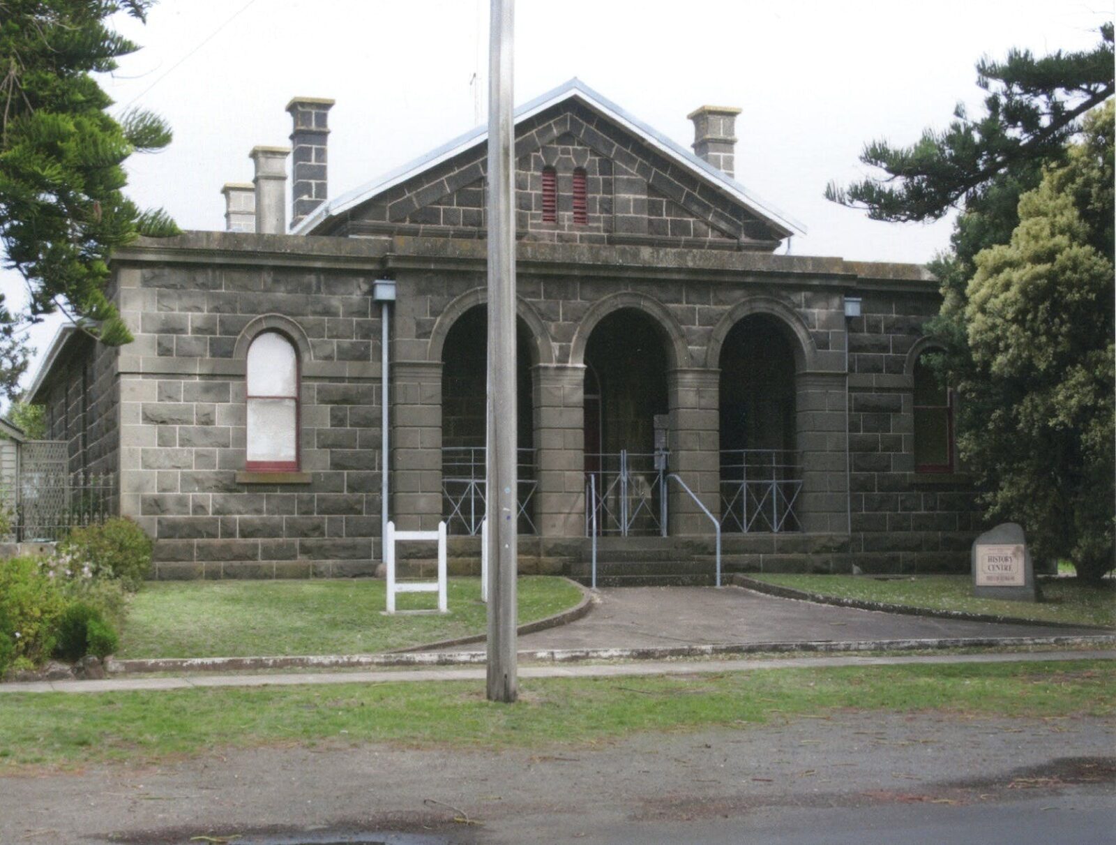 Bluestone building with a 3 arched porch