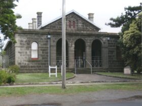 Bluestone building with a 3 arched porch