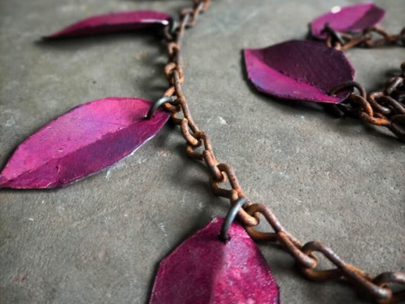 Pink metal leaves on a rusty chain