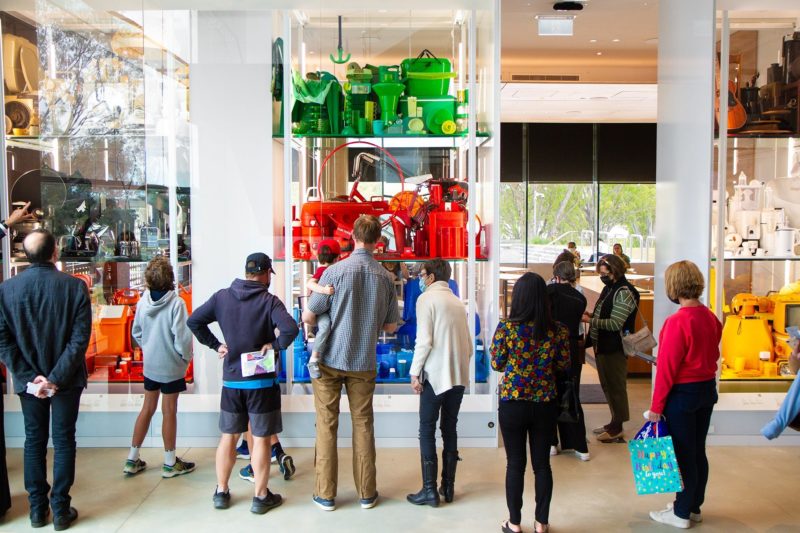 Several people gathered in front of coloured block display of the Everyday Australian Design