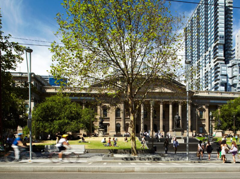 A photo of the State Library Victoria forecourt and lawns on a sunny day