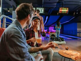 Group enjoy food and drinks with bowling