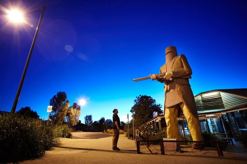 Taking photo in front of Ned Kelly Statue at sunset