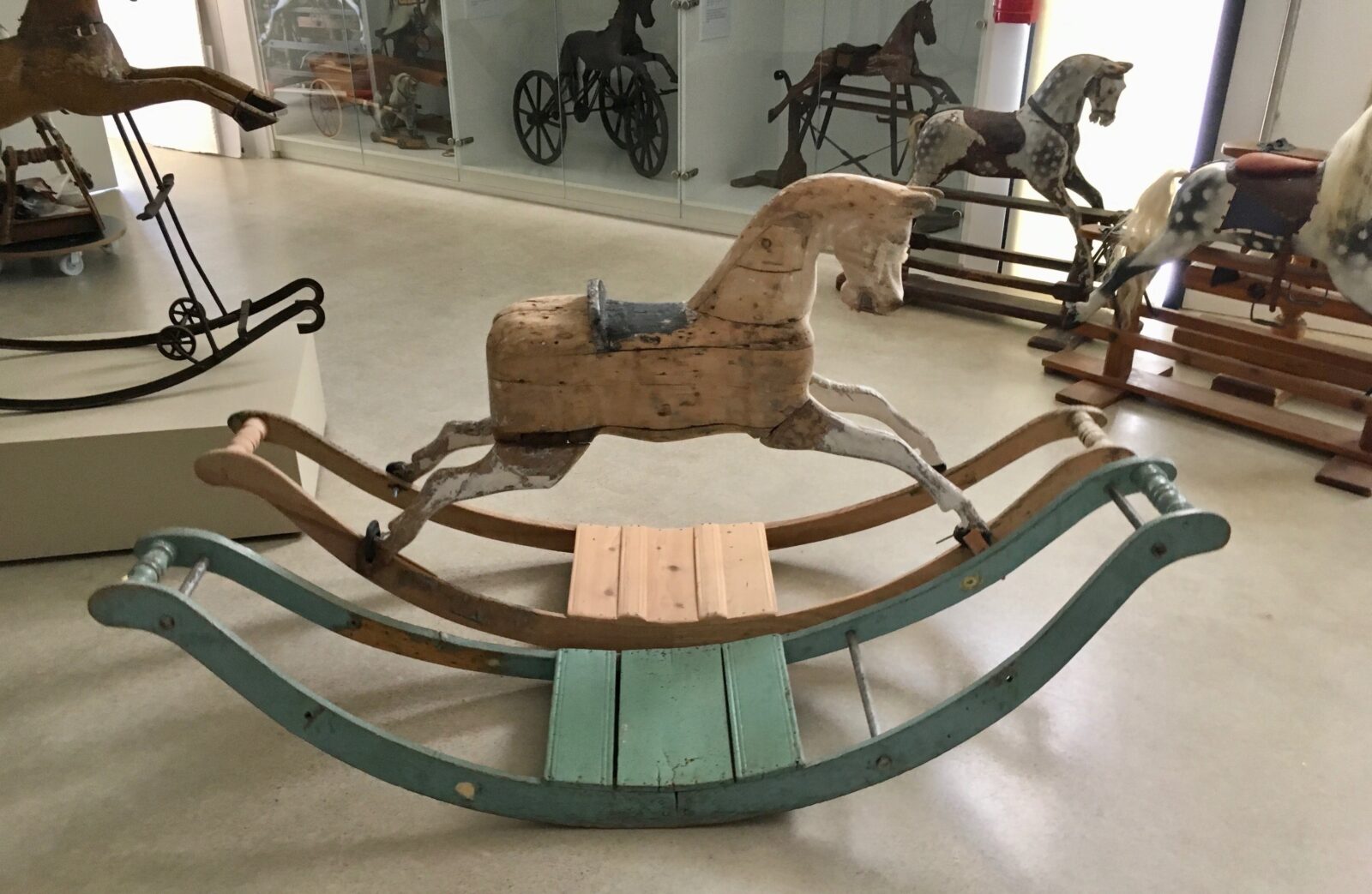 Inside the Equus Museum with a bow rocking horse during restoration.