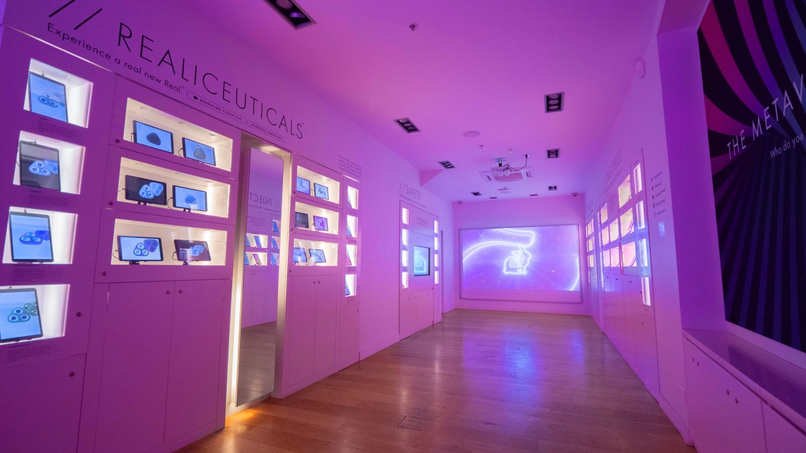 A view of The Meteaverse Store, lit up by purple LED lights and a selection of futuristic art