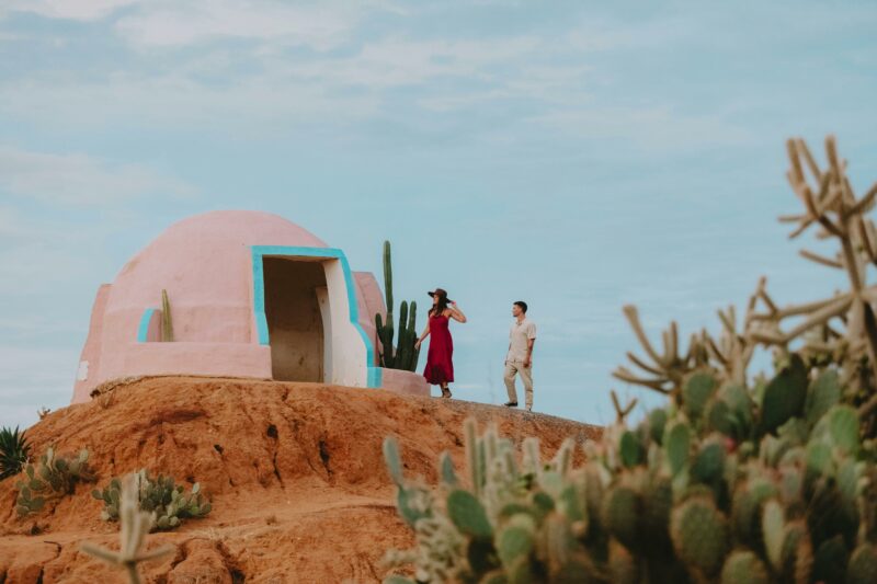 A young couple enjoying the view from a rendered Mexico themed Pink lookout dome.