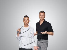 Anthony Callea with a microphone cord wrapped around his body, Tim Campbell shrugs