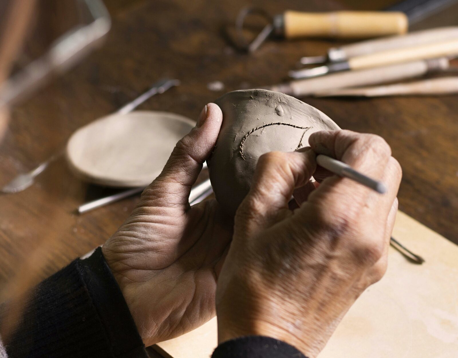 hands crafting clay
