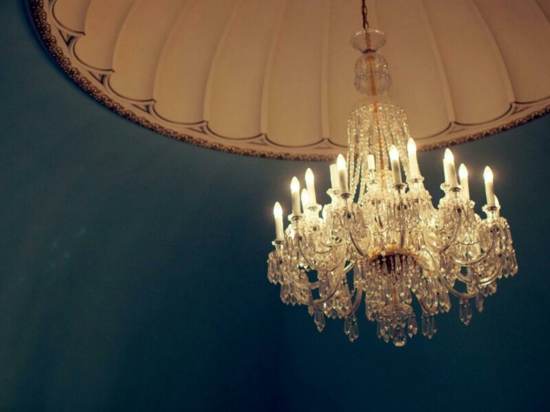 Chandelier against a blue ceiling with Victorian Features